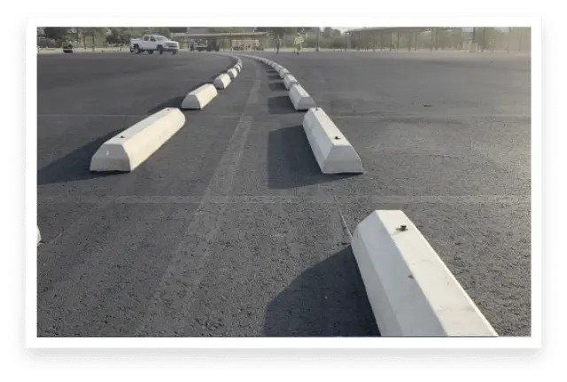 Photo of parking stops on freshly paved asphalt